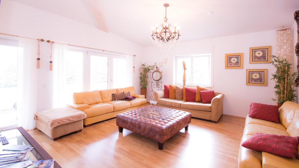 a living room with couches and a coffee table at Deluxe Loft Mountain View in Bad Reichenhall