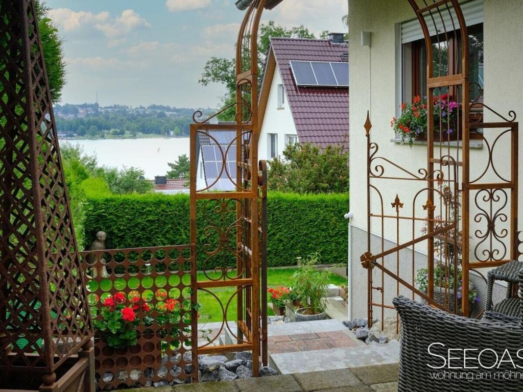 an entrance to a house with a gate and flowers at Holiday apartment with 1 bedroom in Südrandweg