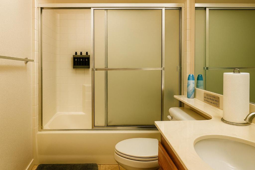a bathroom with a shower and a toilet and a sink at Sundance Retreat in Hemet