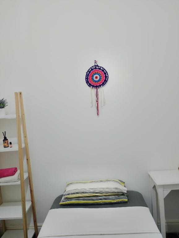 a room with a bed and a dream catcher on the wall at Mi casa in Rosario