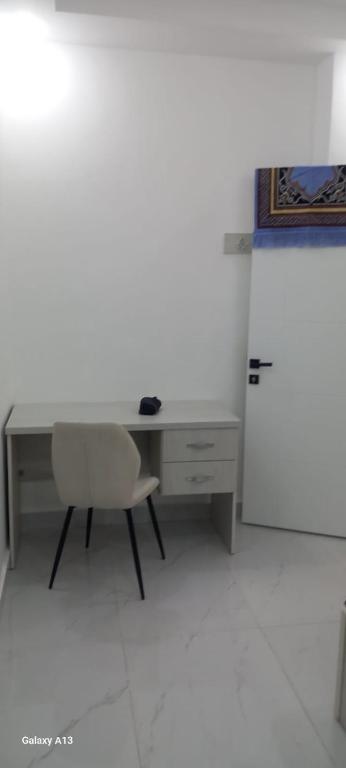 an office with a desk and a chair and a refrigerator at غزو 15 in Aydūn