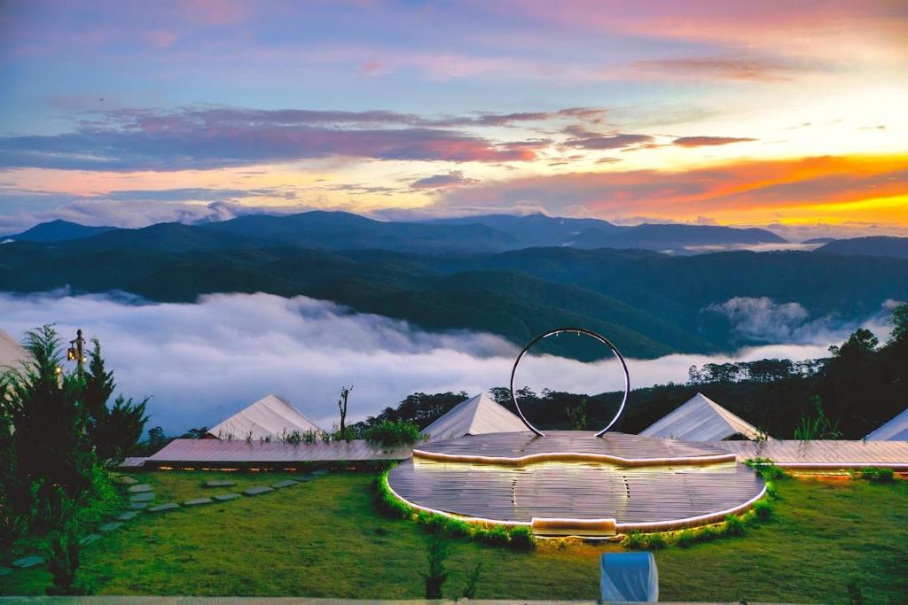 a view of a building with a view of the mountains at Cloud View Glamping Da Lat & Cloud 9 Săn Mây Cầu Đất in Da Lat