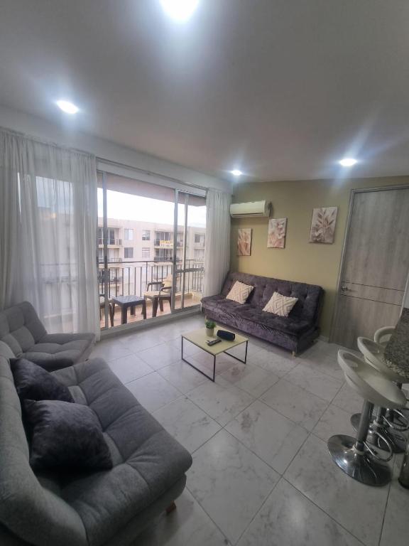 a living room with a couch and a table at Suite Vista Azul Ricaurte in Ricaurte
