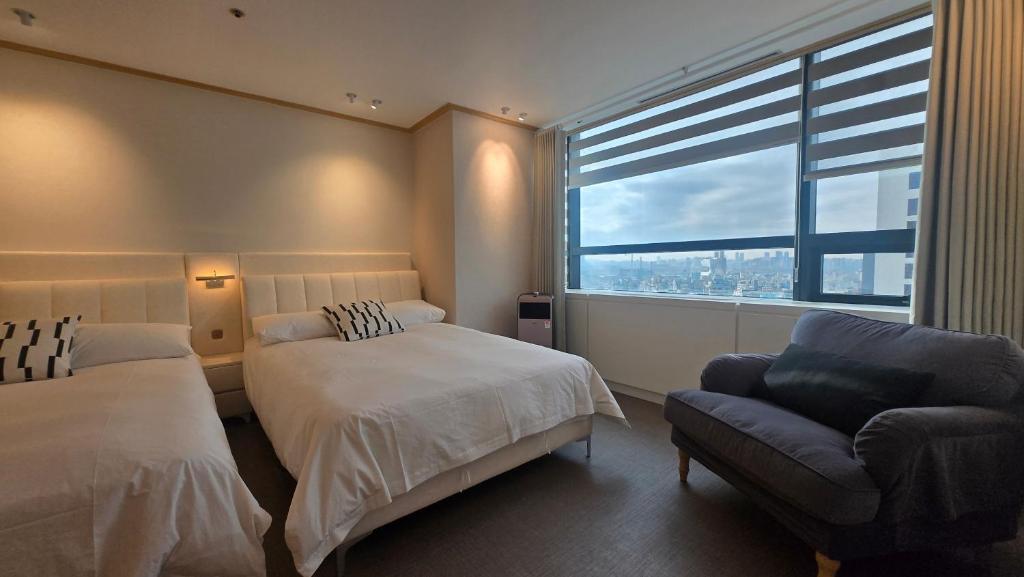 Ένα ή περισσότερα κρεβάτια σε δωμάτιο στο Oasis Hongdae Central