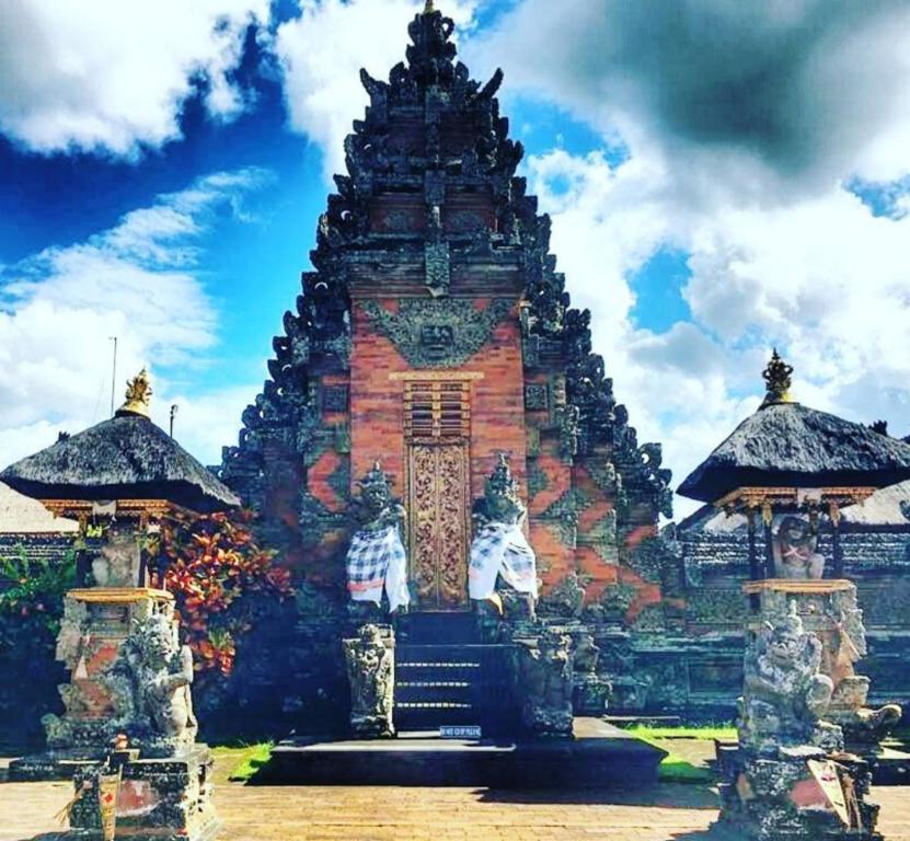 a large building with a tower in front of it at Ubud Classic Day Trip in Pesanggaran