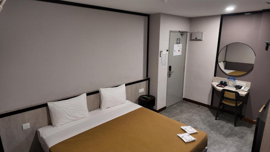 Postel nebo postele na pokoji v ubytování Urban Inn, Jitra