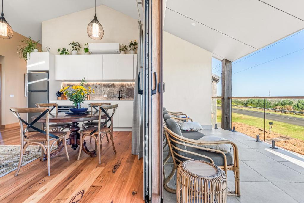 a kitchen and dining room with a table and chairs at Crater View Boutique Eco Apartment in Koroit