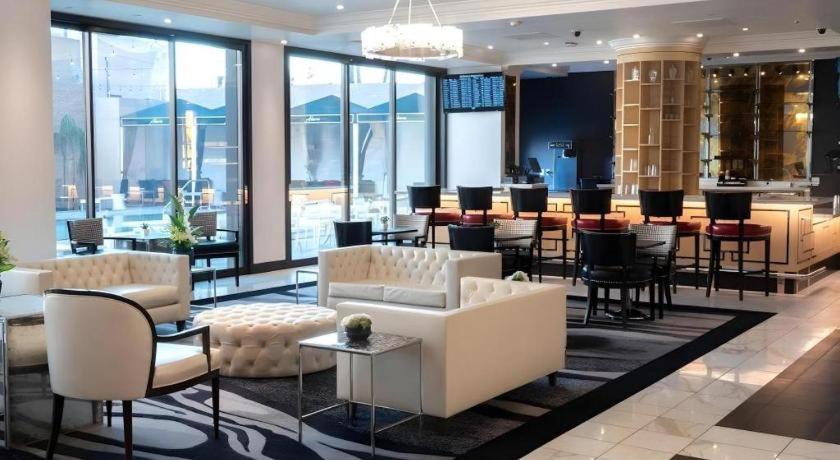 a hotel lobby with tables and chairs and a bar at Ahern Hotel and Event Center in Las Vegas