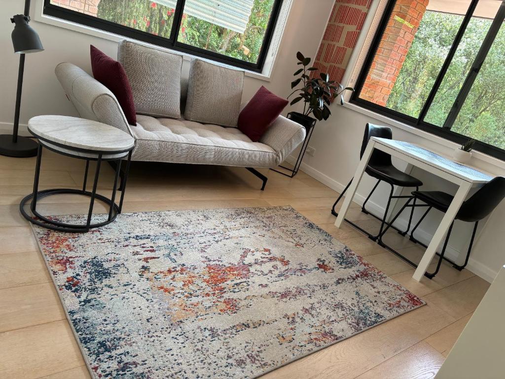 a living room with a couch and a table at Adorable 1 bedroom private apartment in Bright