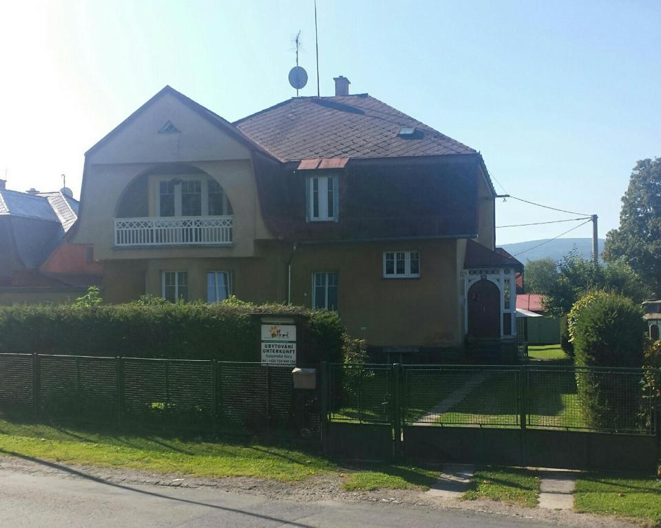 una casa con una valla delante de ella en Apartmány Mikeš en Kašperské Hory