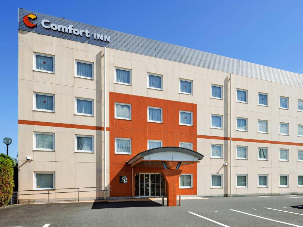 a building with a sign on the front of it at Comfort Inn Tsuchiura Ami in Tsuchiura