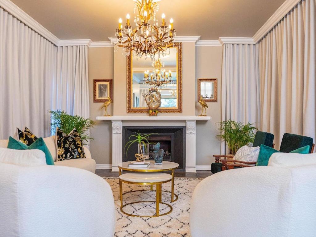 a living room with a chandelier and a fireplace at The First House Luxury Villa, Eden Rock Estate in Pennington