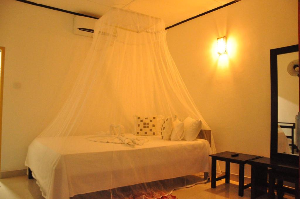 Postel nebo postele na pokoji v ubytování Sigiri Rock Side Home Stay