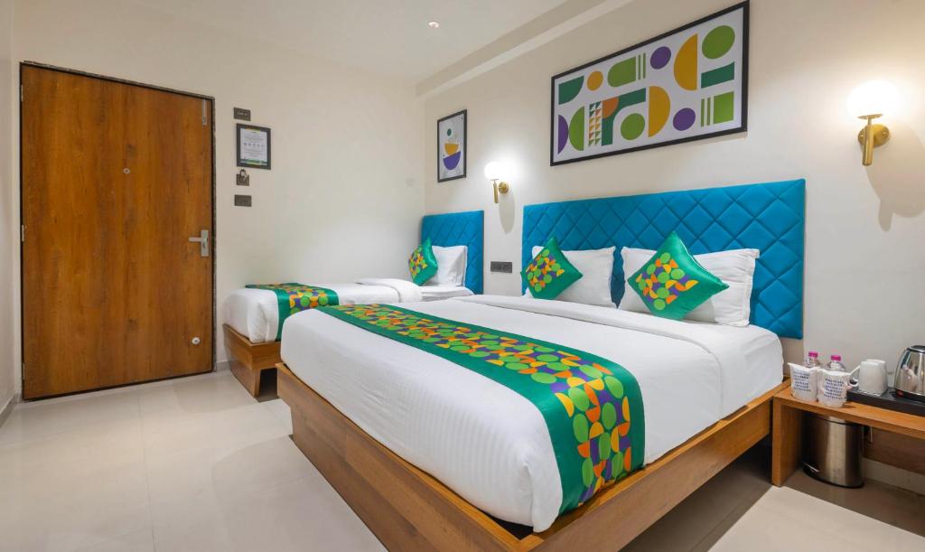 a bedroom with two beds in a room at Treebo Executive Suites in Gandhinagar