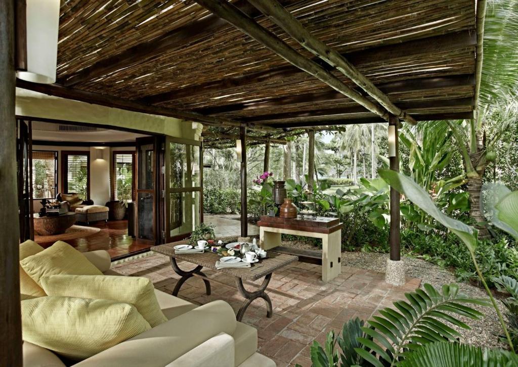a living room with a couch and a table at Rayavadee - Terrace Pavilion in Railay Beach