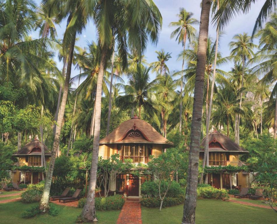 a house in the middle of palm trees at Rayavadee - Deluxe Pavilion in Railay Beach