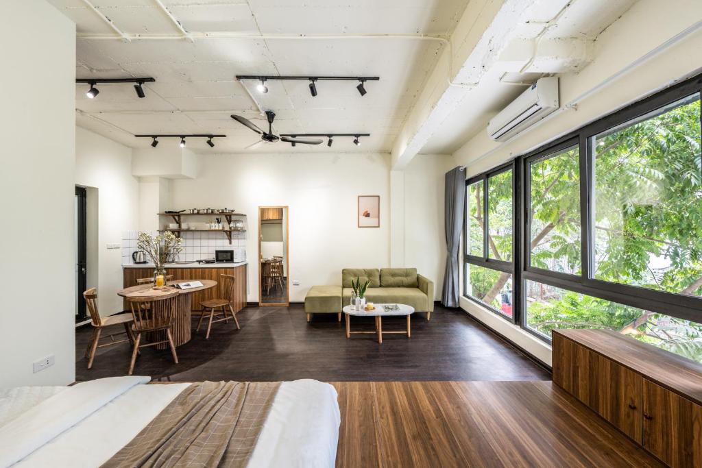 an open living room with a large window at Sweet Home in Hanoi