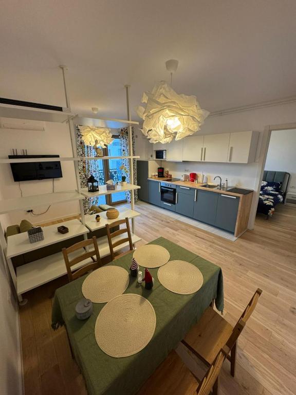 a kitchen and living room with a table and chairs at Central monarch 1 P&P Residence in Timişoara