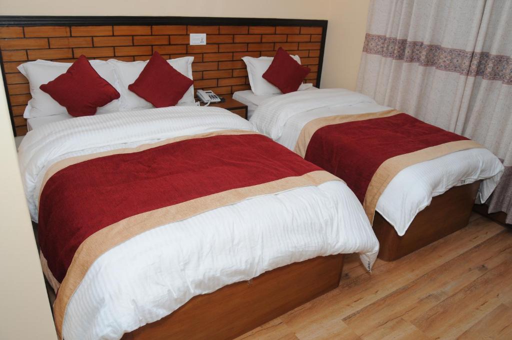 Postel nebo postele na pokoji v ubytování Hotel Bagmati