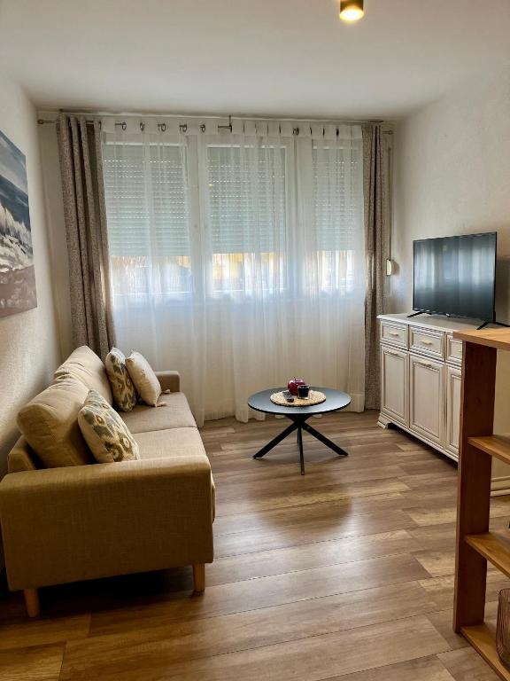 a living room with a couch and a table at Apartman Nota in Vinkovci