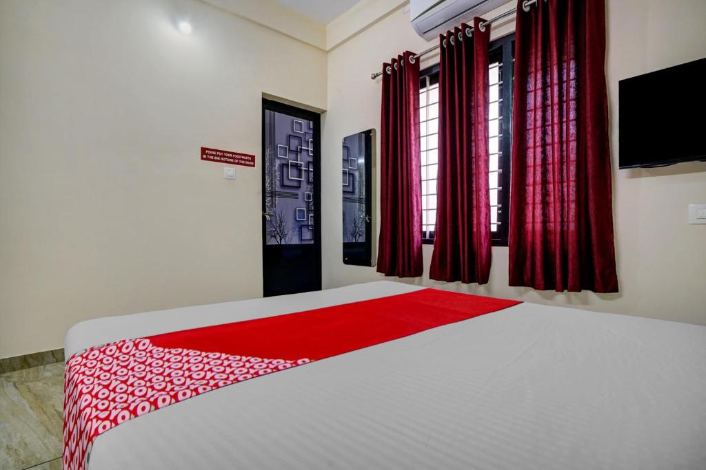 Ένα ή περισσότερα κρεβάτια σε δωμάτιο στο Hotel O Versatile Inn