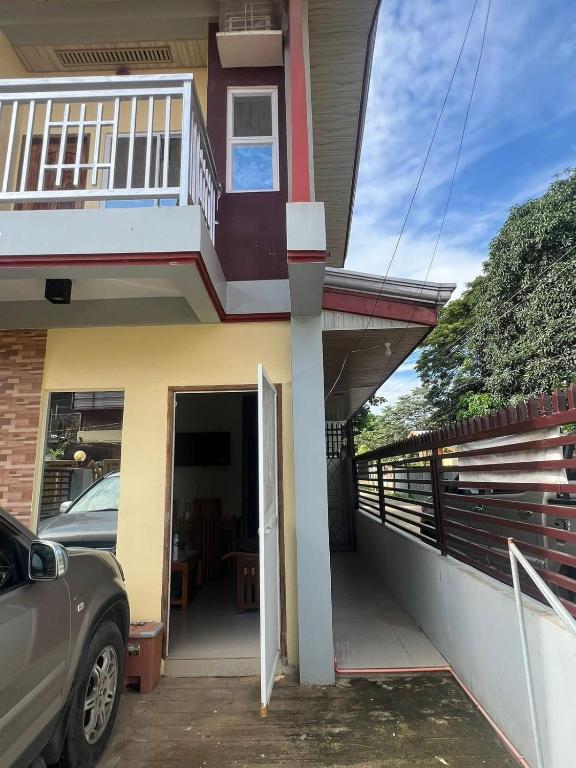 a house with an open door and a balcony at Westlinehomestay in Puerto Princesa City