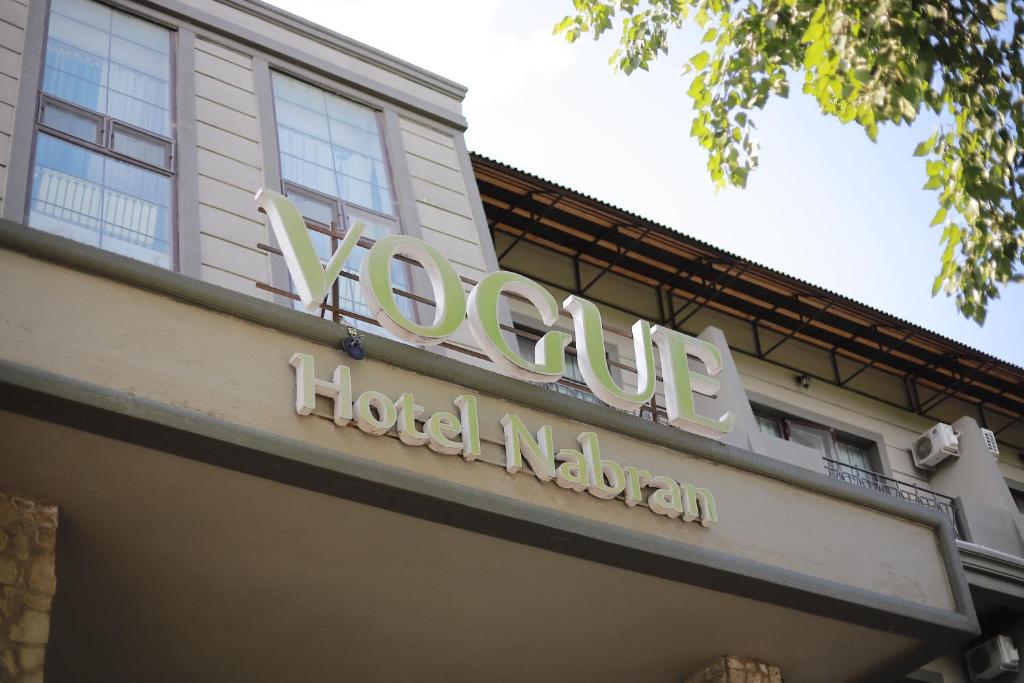 a sign on the front of a hotel lobby at Vogue Nabran Hotel in Xaçmaz