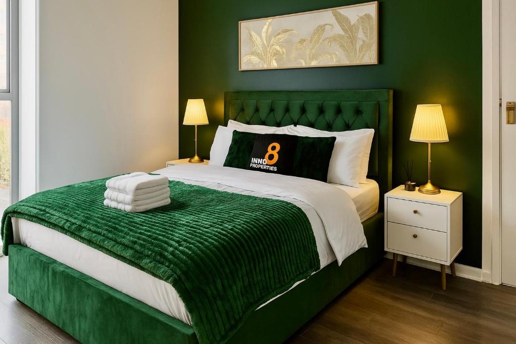 a green bedroom with a bed with a green comforter at Cinema Lounge 2Bed Leeds City Centre FREE Parking in Leeds