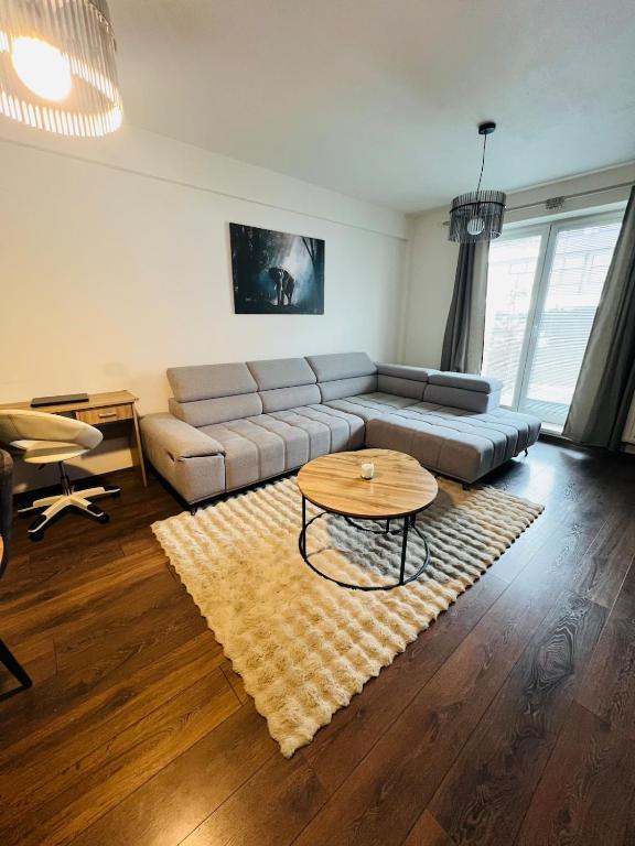 a living room with a couch and a table at Zilina Sweet Escape in Žilina