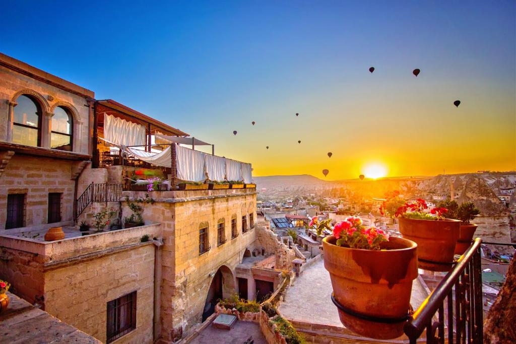 a view of a city with flower pots on a balcony at Kelebek Special Cave Hotel & Spa in Goreme