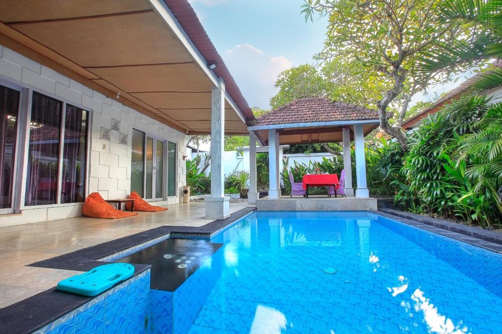 a swimming pool in a house with a gazebo at Privat Pool Villa at Kuta in Kuta