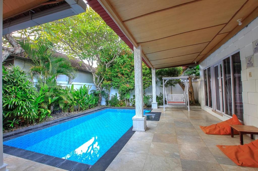 a swimming pool in the backyard of a house at Privat Pool villa at kuta in Kuta