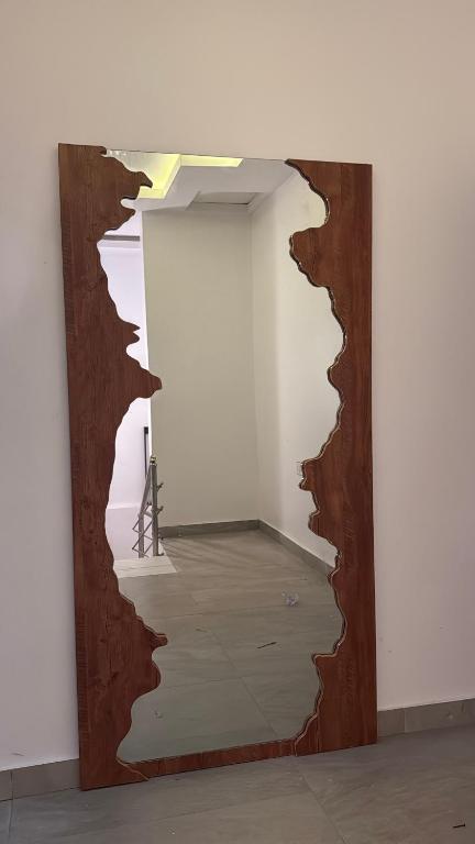 a mirror with a hole in a wall at Quantum Havens Apartment - LISBON in Akure