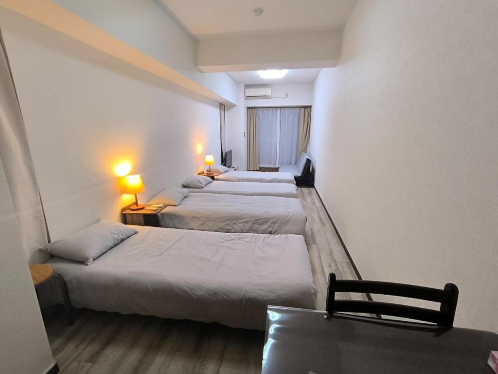 Postel nebo postele na pokoji v ubytování 8Close to the station, 2 stations can be used, spacious space, maximum 5 people