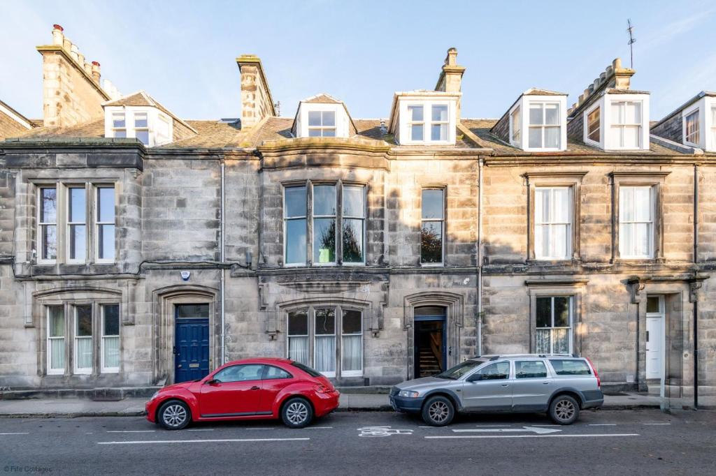 two cars parked in front of a building at 12A Queens Gardens, St Andrews in St. Andrews