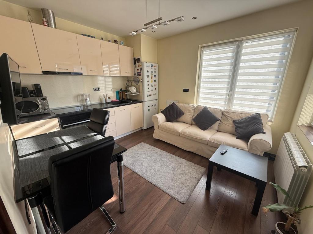 a living room with a couch and a kitchen at Pasarel House in Pasarel
