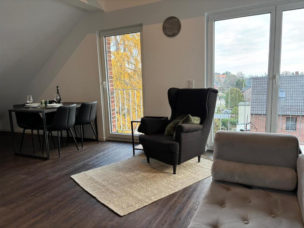 a living room with a couch and a chair and a table at Loftbude in Hürth