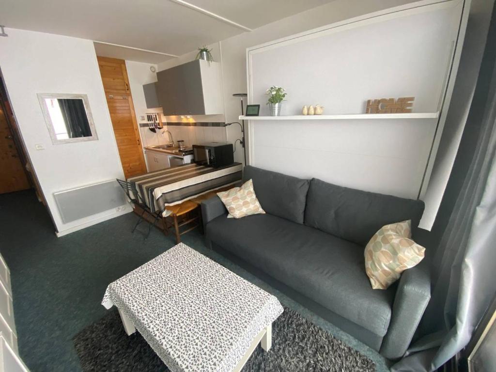 una sala de estar con un sofá y una mesa en Studio cosy pour 4 avec balcon et Wi-Fi, accès direct aux pistes - FR-1-602-59, en Arette