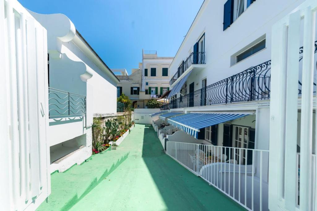 an empty alley between two buildings with balconies at In pieno centro vicino al mare in Ischia Town