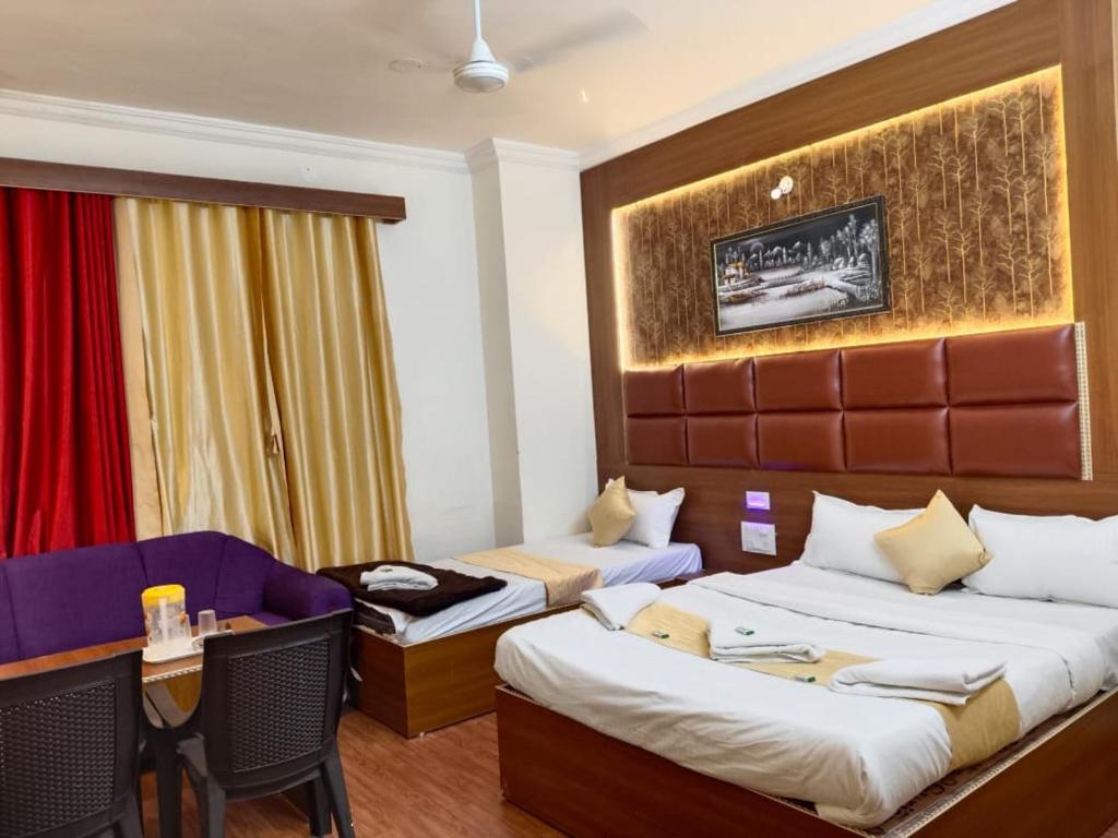 a hotel room with two beds and a desk at Hotel classic inn in Hyderabad