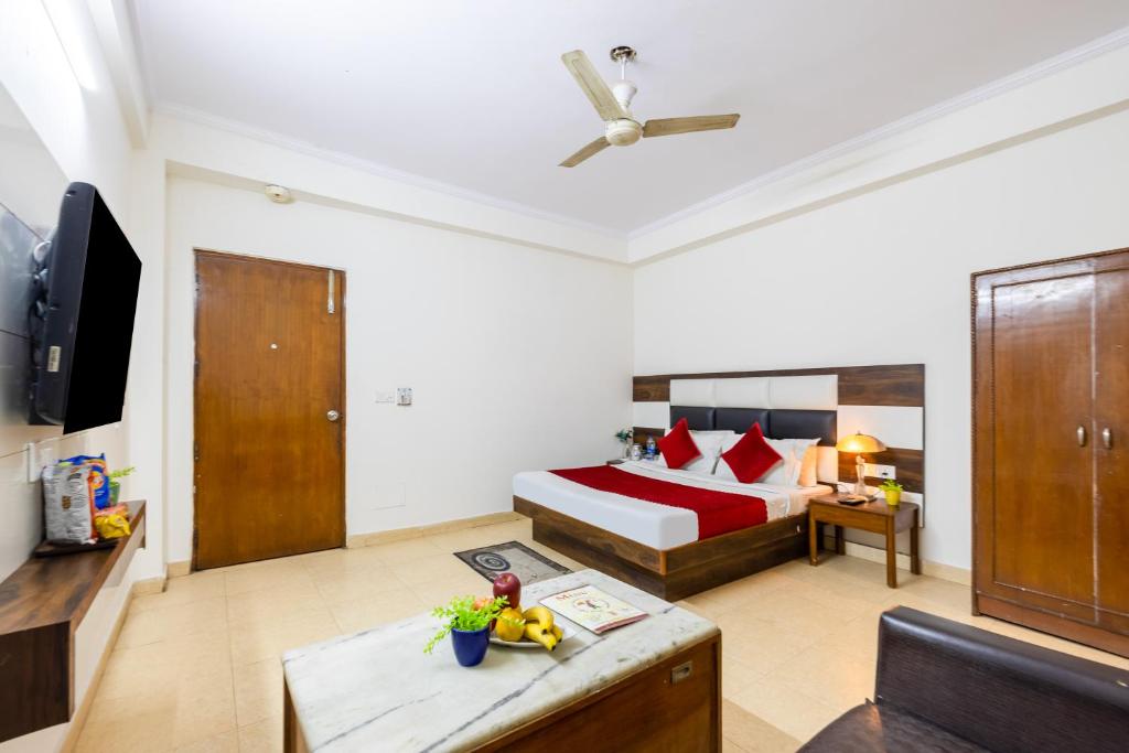 a hotel room with a bed and a television at Trevon Inn Karol Bagh, New Delhi in New Delhi
