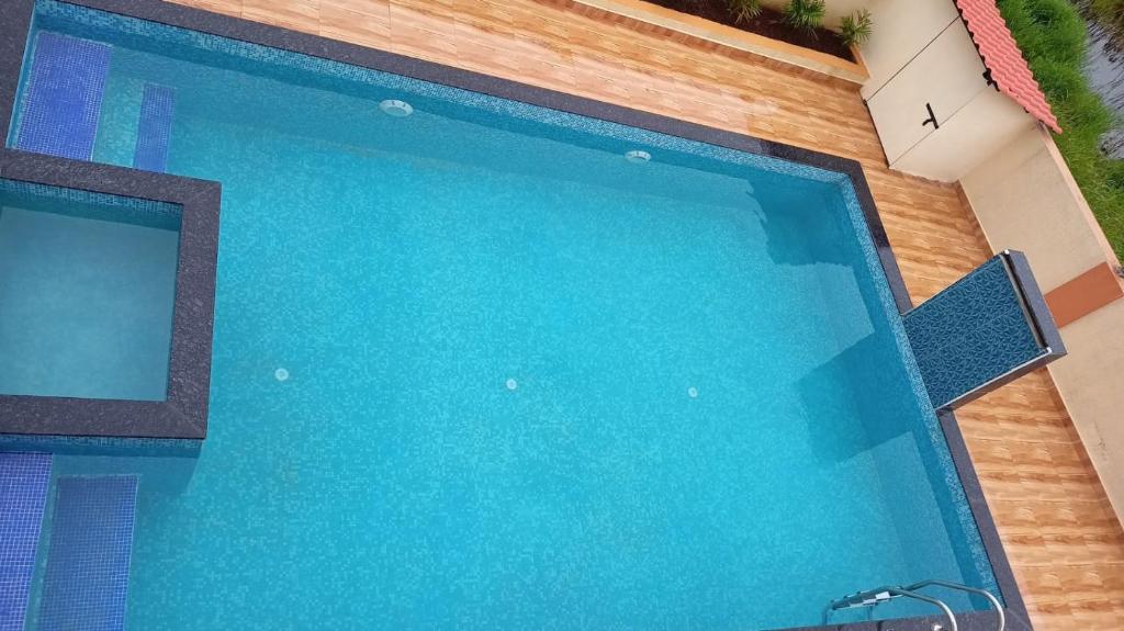 a large swimming pool with blue water at Paradise in Malavli