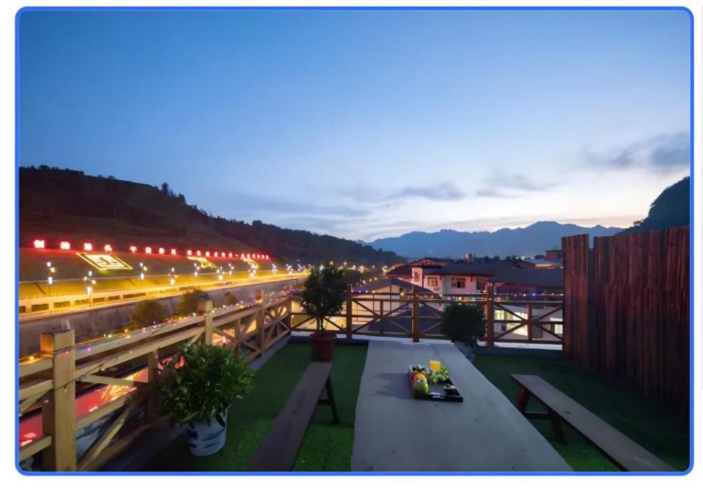 a view of a city at night with a bridge at Zhangjiajie Oxygen Lodge in Zhangjiajie