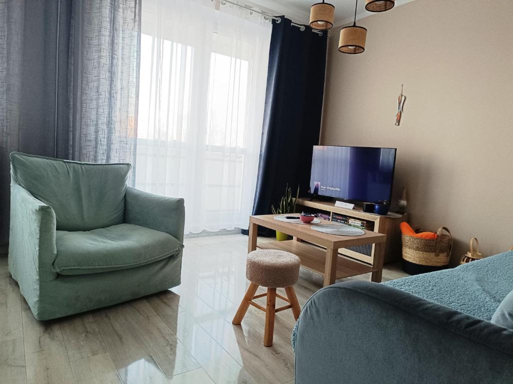 TV a/nebo společenská místnost v ubytování Przytulny Kąt