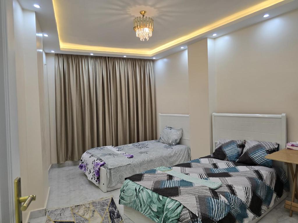 Postel nebo postele na pokoji v ubytování SR Grand House