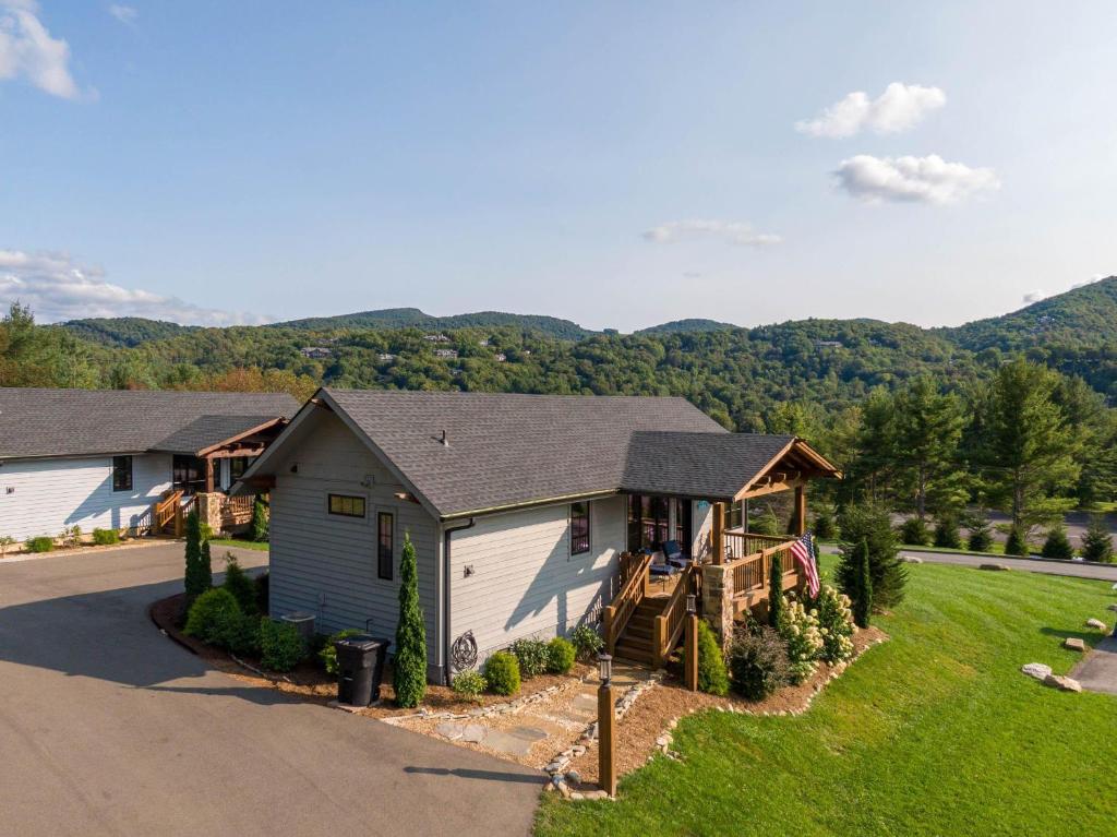 a house with a porch and a house with a deck at Valley View in Banner Elk