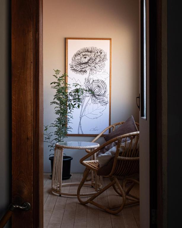 a room with a chair and a picture on the wall at New Open KIKUNOYA-sora- in Nagoya