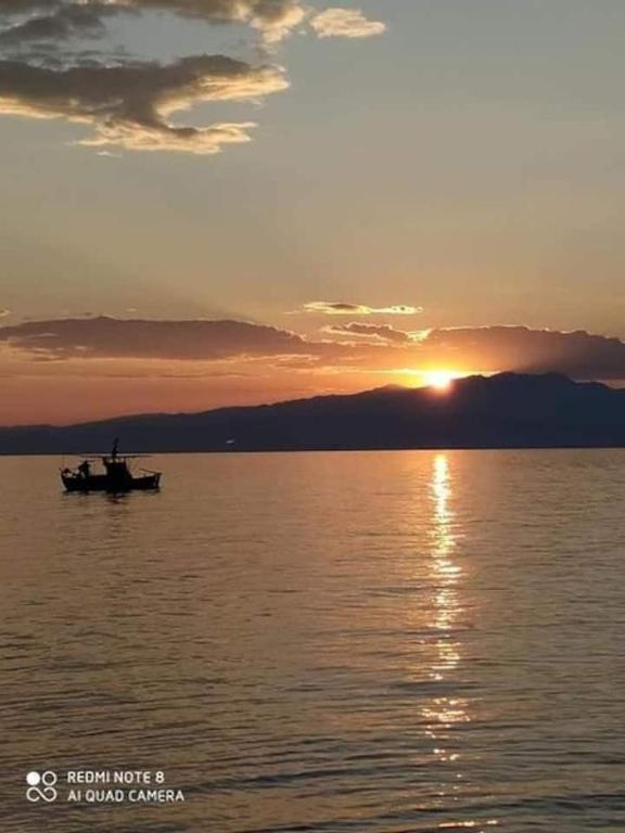 a boat in the middle of a lake at sunset at lady diana in Skala Kallirachis
