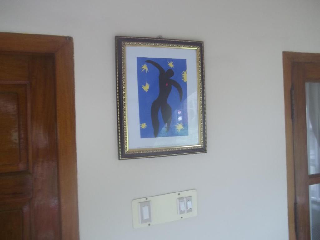 a picture of a person on a wall at Maharaju Palace in Kovalam