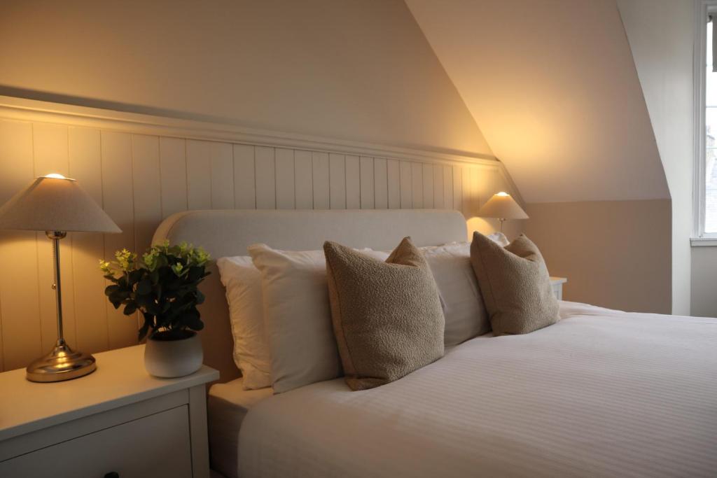 a bedroom with a bed with white pillows at Harbourside Hotel in Irvine